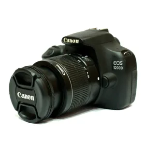 A black Canon EOS 1200D DSLR camera with an attached 18-55mm zoom lens. The camera is positioned at a three-quarter angle on a white background, featuring the Canon logo on the flash housing and lens cap, with "EOS 1200D" clearly visible on the body.